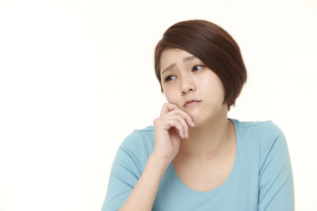 studio shot of young Japanese woman on white background